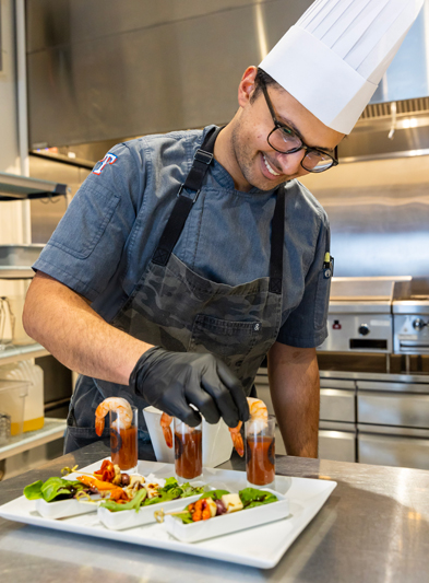 Sous chef decorating a plate at Globe Life Field