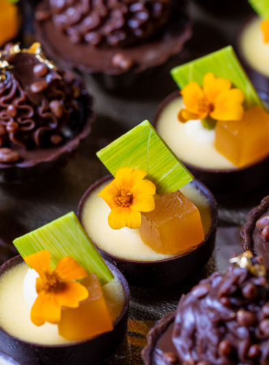 A close up of rows of small desserts from Emmy's.