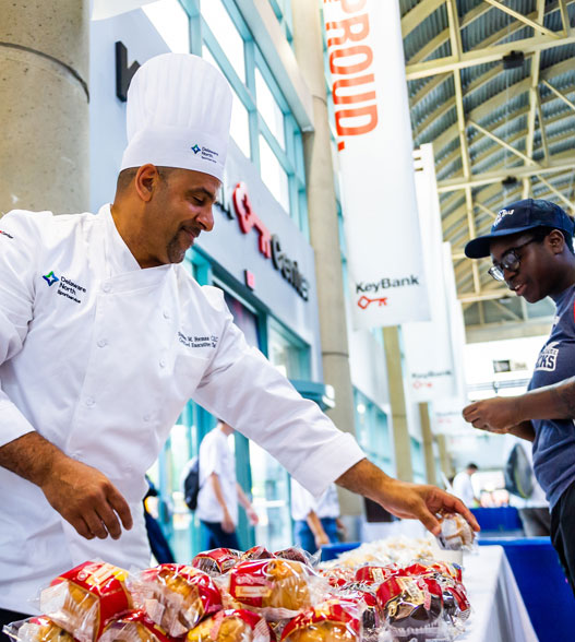 A chef and associate working at a community event.
