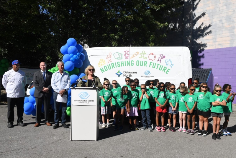 group of children from the Boys and Girls club and Delaware North employees outside celebrating