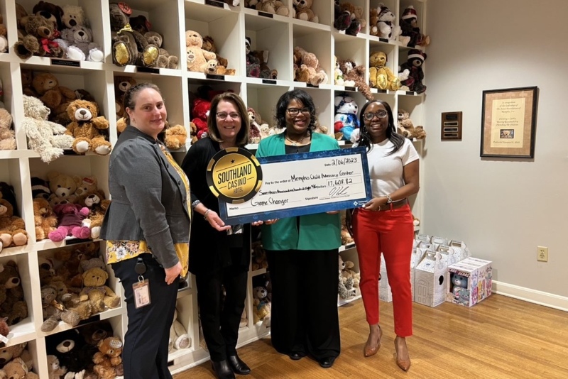 image of women holding a check to the Memphis Child Advocacy Center
